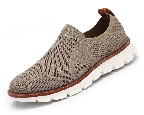 Beige knit slip-on shoe with white chunky sole and brown leather trim detail, shown from side angle against white background.