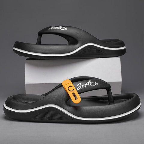 Two black sandals with white curved trim and contoured soles displayed on white box. Lower sandal features orange and black