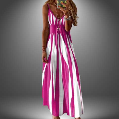 Woman wearing a sleeveless magenta and white vertical striped midi dress with a v-neckline, standing against a gray