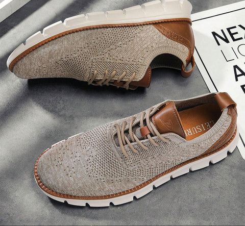 Pair of casual shoes with beige knit uppers and tan leather trim, white rubber soles, and brown laces, displayed on gray