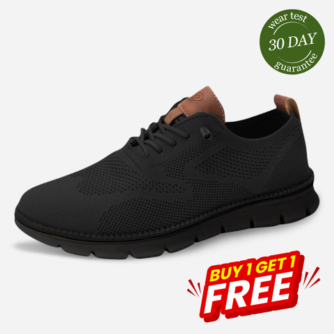 Black knit lace-up sneaker with brown leather heel collar and chunky black sole, shown in profile against white background.