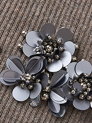 Decorative brooch featuring gray and white frosted petals arranged in flower clusters with metallic silver beads and dark