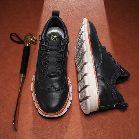 Black leather sneakers with white and orange sole trim, displayed on terracotta background with decorative gold-handled cane