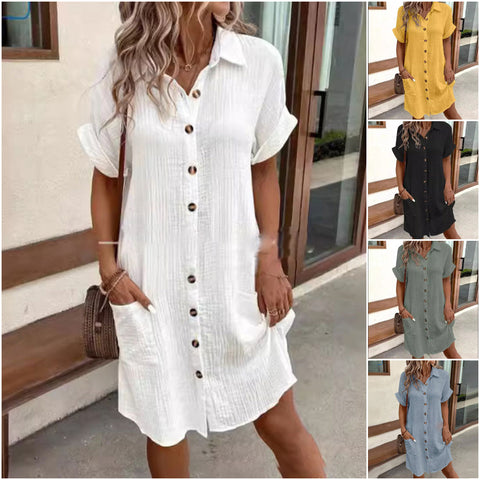 Woman wearing white button-front shirt dress with short sleeves, standing outdoors. Dress shown in multiple color options