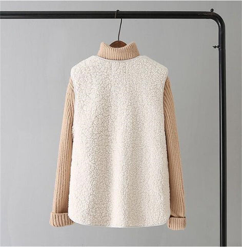 Cream and beige colorblock turtleneck sweater with textured knit body and ribbed sleeves, displayed on hanger against gray