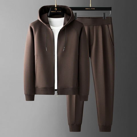 Brown zip-up hoodie with white shirt underneath and matching brown joggers with cuffed ankles, displayed on hangers against