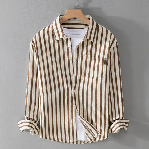 Striped button-up shirt in tan and cream vertical stripes with white undershirt, displayed on wooden hanger against gray