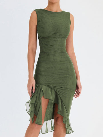 Woman wearing sleeveless olive green dress with ruched horizontal detailing and asymmetrical ruffled hem, standing against